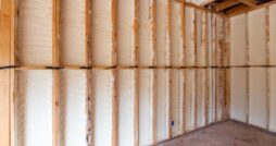 A wall in a new home build with spray foam insulation mid-construction.