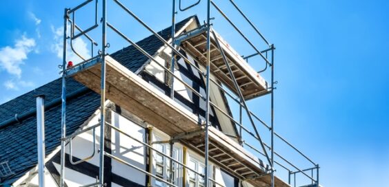 A close-up of a reconstruction and renovation of an old half-timbered historic house on a sunny day.