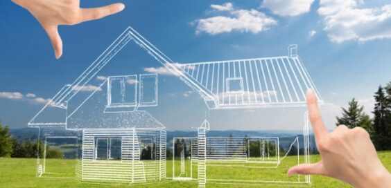 A pair of hands framing a house sketch that has been overlaid on a backdrop of an open section of land.