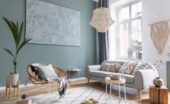 Modern living room with neutral furniture, woven pendant light, abstract wall art, and abundant natural light.