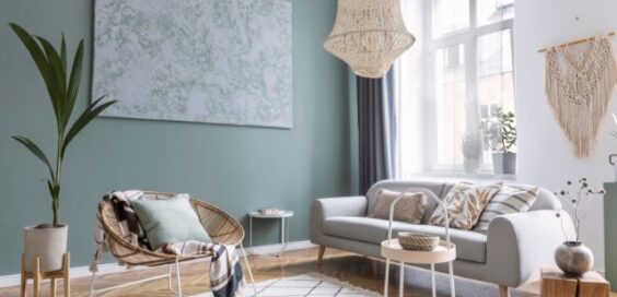 Modern living room with neutral furniture, woven pendant light, abstract wall art, and abundant natural light.